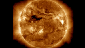 Un'immagine del Sole in ultravioletto che mostra molta attività e un flare verso il lato destro del disco, saturando la telecamera.