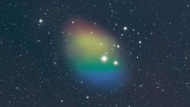 A rainbow coloured cloud is overimposed to a starry background