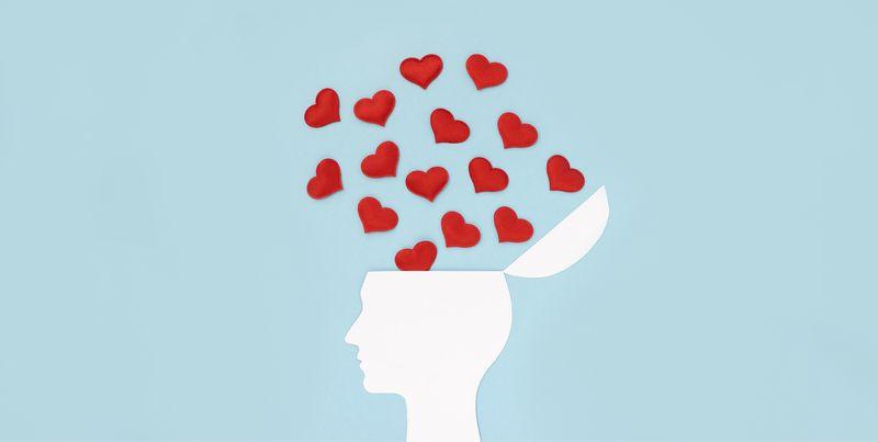 white silhouette of human with head hinged open and red hearts flowing out and upwards, on light blue background