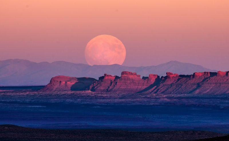 The full moon rises over Monument Valley on Navajo Tribal Land on the Utah-Arizona border.