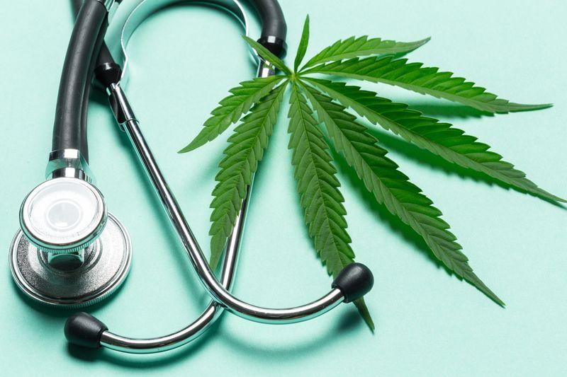 a-cannabis-leaf-next-to-a-stethoscope-on-a-turquoise-background-m-1.jpg