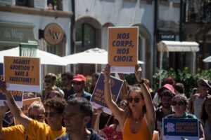 manifestanti che tengono cartelli durante una marcia per i diritti all'aborto a Strasburgo nel 2022