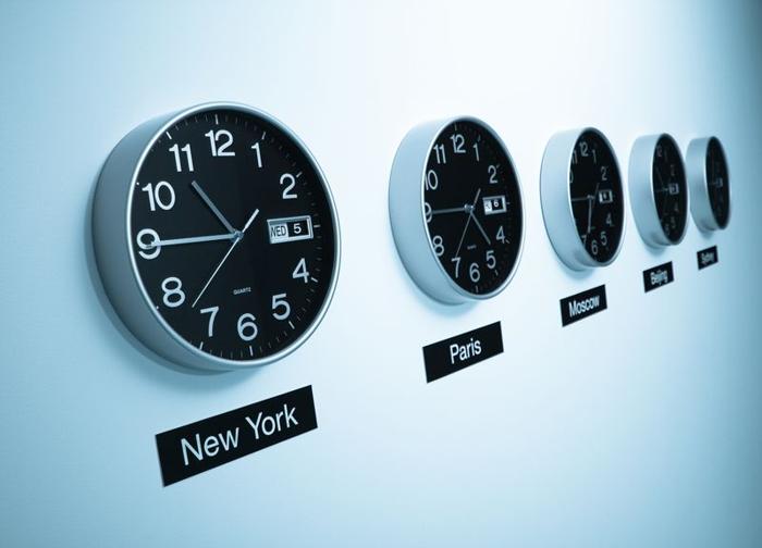 Una fila di orologi che mostrano l'ora in diverse città internazionali, come New York e Parigi.