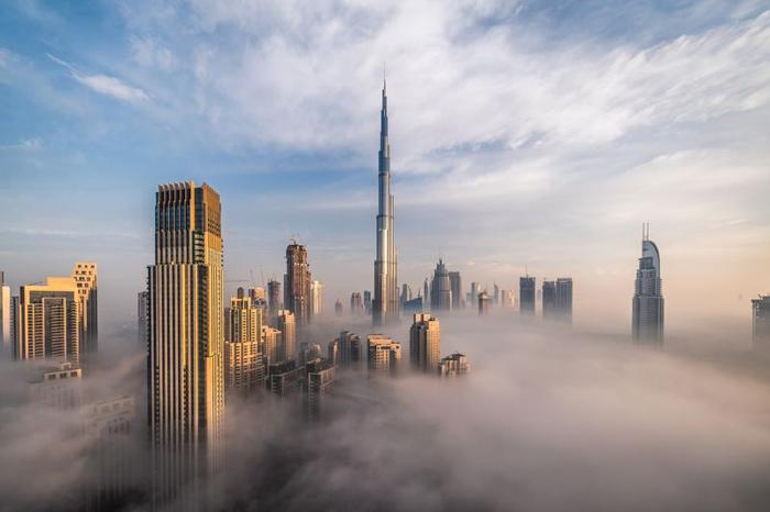 Downtown Dubai in the UAE with skyscrapers submerged in think fog and clouds