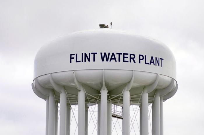 La torre dell'acqua di Flint è bianca e ha scritto impianto di trattamento dell'acqua di Flint su di essa.