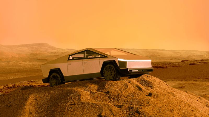 Un Tesla Cybertruck su una duna di sabbia.