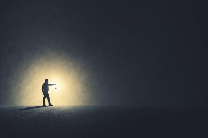 man-walking-in-the-dark-with-lamp-illuminating-his-path-m-1.jpg