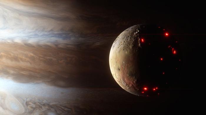 Lava pools glowing on the night side of Jupiter's moon, Io, the most volcanic world in our solar system in this render, Jupiter looms massively behind