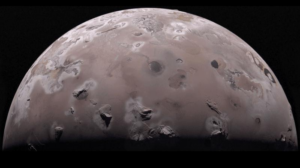 metà del disco della luna è visibile. i vulcani e il lago di lava coprono la superficie rossastra della luna