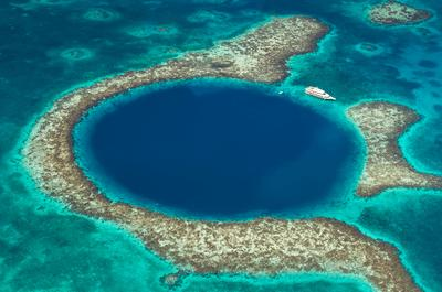 Una barca vicino al Grande Buco Blu, un'imboccatura marina nei fondali di Belize, Mar dei Caraibi