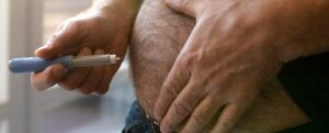 uomo che si inietta un farmaco per la perdita di peso