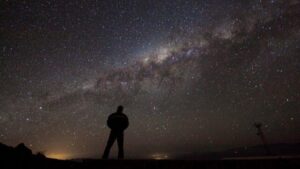 silhouette di una persona che guarda il cielo notturno