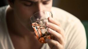 Uomo che beve da un bicchiere