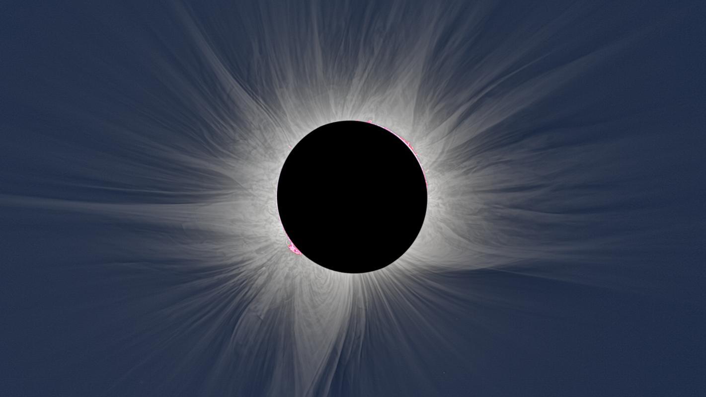 Primo piano di un’eclissi solare totale: grandi pennacchi bianchi si allungano dal Sole; questa è la corona solare.